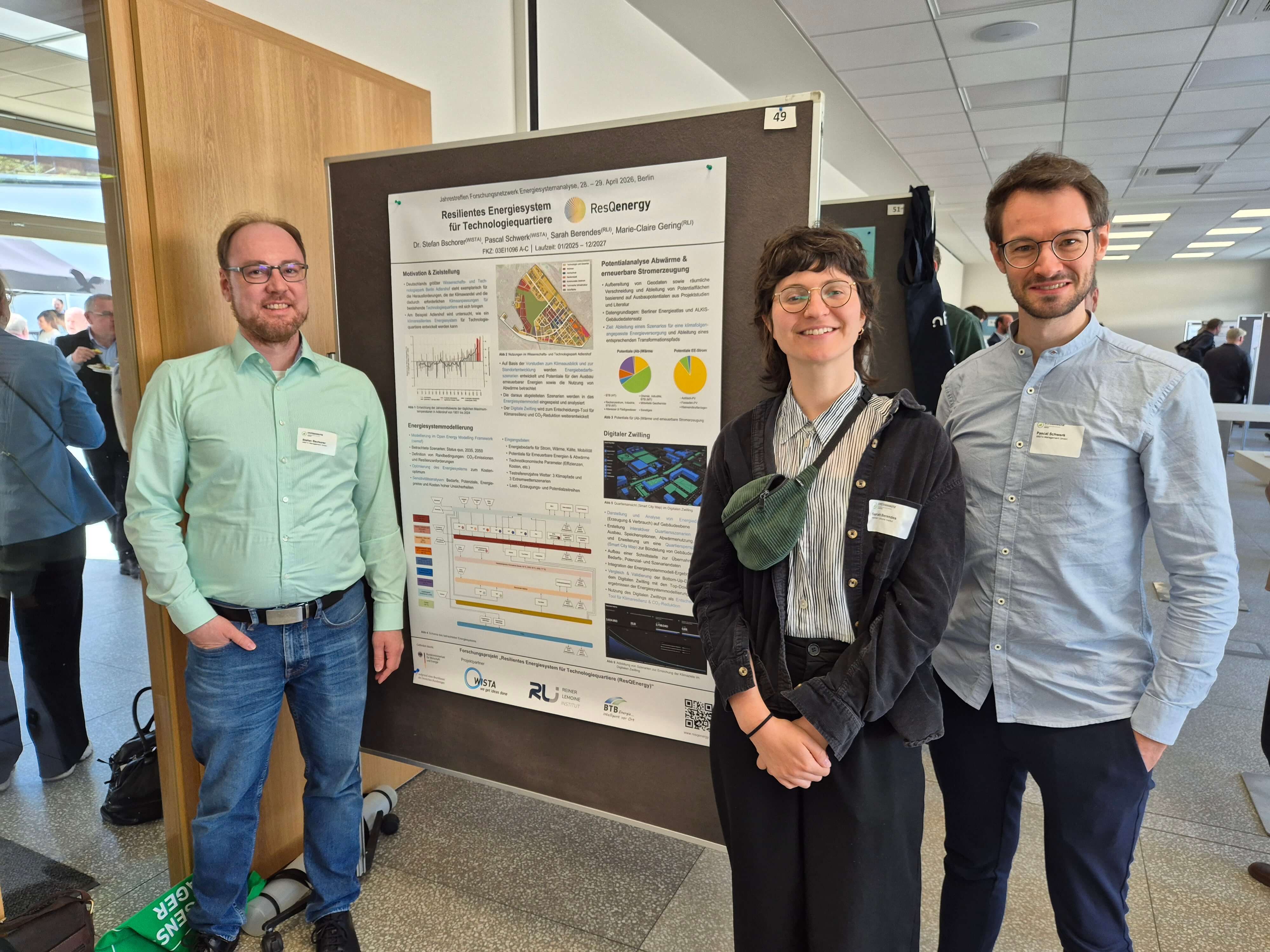 Drei Personen präsentieren ein Forschungsplakat über resiliente Energiesysteme bei einer Konferenz. | © Pascal Schwerk